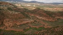 5.5K aerial stock footage of approaching canyons, mountains reveal green valley, Capitol Reef National Park, Utah Aerial Stock Footage | AX130_339E