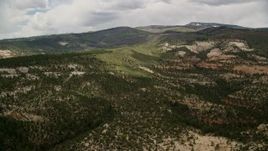 5.5K aerial stock footage of flying by low, green mountains, Dixie National Forest, Utah Aerial Stock Footage | AX130_350