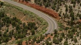 5.5K aerial stock footage of tracking a black SUV traveling on Route 12 bend, Boulder, Utah Aerial Stock Footage | AX130_380E