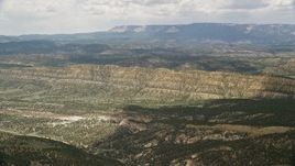 5.5K aerial stock footage of flying over a valley, approaching a mountain ridge, Grand Staircase-Escalante National Monument, Utah Aerial Stock Footage | AX130_394E