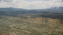 5.5K aerial stock footage of approaching a mountain ridge from a wide valley, Grand Staircase-Escalante National Monument, Utah Aerial Stock Footage | AX130_396