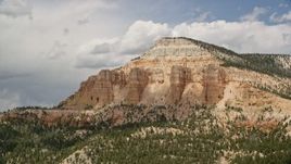 5.5K aerial stock footage of flying by the side of Barney Top Mesa, Utah Aerial Stock Footage | AX130_401