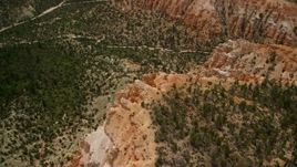 5.5K aerial stock footage orbiting a steep cliff, revealing hoodoos, Bryce Canyon National Park, Utah Aerial Stock Footage | AX130_449