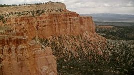 5.5K aerial stock footage of flying by groups of hoodoos, mesa cliffside, Bryce Canyon National Park, Utah Aerial Stock Footage | AX130_469E