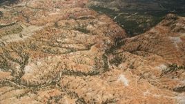 5.5K aerial stock footage of flying over hills near hoodoos, Bryce Canyon National Park, Utah Aerial Stock Footage | AX130_485