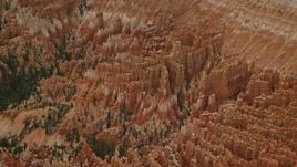 5.5K aerial stock footage of flying away from hoodoos, buttes, seen from over parking area, Bryce Canyon National Park, Utah Aerial Stock Footage | AX130_488E