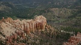 5.5K aerial stock footage of flying by butte, surrounded by trees, Bryce Canyon National Park, Utah Aerial Stock Footage | AX131_012