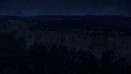 4K day for night color corrected aerial footage of flying by rock formations, Pink Cliffs, trees, Bryce Canyon National Park, Utah Aerial Stock Footage | AX131_021_DFN