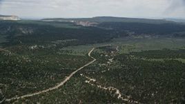 5.5K aerial stock footage of flying over dirt road, forest, Grand Staircase-Escalante National Monument, Utah Aerial Stock Footage | AX131_039E