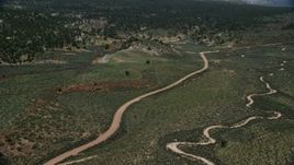 5.5K aerial stock footage fly over dirt roads near forest, Grand Staircase-Escalante National Monument, Utah Aerial Stock Footage | AX131_042