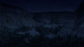 4K day for night color corrected aerial footage of flying low through a canyon, Grand Staircase-Escalante National Monument, Utah Aerial Stock Footage | AX131_049_DFN