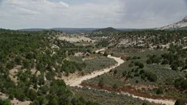 5.5K aerial stock footage of a dry riverbed in the hills, Grand Staircase-Escalante National Monument, Utah Aerial Stock Footage | AX131_058E