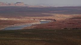 5.5K aerial stock footage of passing by Lake Powell and desert, Glen Canyon National Recreation Area, Utah, Arizona Aerial Stock Footage | AX131_129E