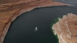 5.5K aerial stock footage tilt to bird's eye view of a boat on Lake Powell in Arizona Aerial Stock Footage | AX131_149
