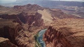 5.5K aerial stock footage of following the Colorado River, bordered by rugged cliffs, Glen Canyon, Arizona Aerial Stock Footage | AX131_188