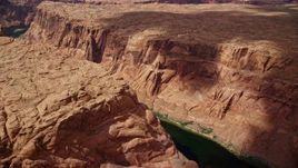 5.5K aerial stock footage of flying over Colorado River at the bottom of deep Glen Canyon, Arizona Aerial Stock Footage | AX131_201E