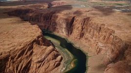 5.5K aerial stock footage of passing by Colorado River and steep cliffs in Glen Canyon, Arizona Aerial Stock Footage | AX131_219E