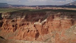 5.5K aerial stock footage of approaching butte in a canyon, tilt to bird's eye view, Navajo Nation Reservation, Utah Aerial Stock Footage | AX132_014E