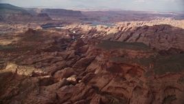 5.5K aerial stock footage wide view of rock formations in canyon near Lake Powell, Navajo Nation Reservation, Utah Aerial Stock Footage | AX132_028E