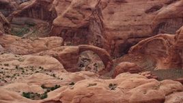 5.5K aerial stock footage of flying by natural stone arch, Rainbow Bridge National Monument, Utah Aerial Stock Footage | AX132_040E