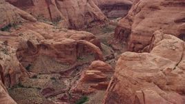 5.5K aerial stock footage pass by a natural stone bridge at Rainbow Bridge National Monument, Utah Aerial Stock Footage | AX132_049
