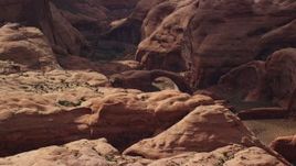 5.5K aerial stock footage of passing by a stone arch, Rainbow Bridge National Monument, Utah Aerial Stock Footage | AX132_052E