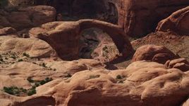 5.5K aerial stock footage of a close-up view of a natural stone bridge, Rainbow Bridge National Monument, Utah Aerial Stock Footage | AX132_060