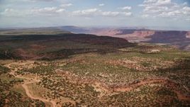 5.5K stock footage video of passing by mesa, approaching wide canyon, Navajo Nation Reservation, Arizona, Utah Aerial Stock Footage | AX132_085E