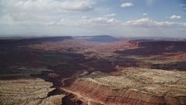 5.5K aerial stock footage of flying by wide desert canyon, Navajo Nation Reservation, Arizona, Utah Aerial Stock Footage | AX132_090E