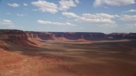 5.5K aerial stock footage of approaching butte in wide valley by mesas, Navajo Nation Reservation, Arizona, Utah Aerial Stock Footage | AX132_097E