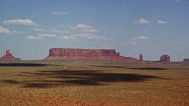5.5K aerial stock footage of approaching Sentinel Mesa, nearby buttes, Monument Valley, Arizona, Utah Aerial Stock Footage | AX132_132
