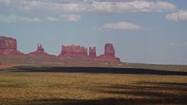 5.5K aerial stock footage of flying by four desert buttes in Monument Valley, Arizona, Utah Aerial Stock Footage | AX132_133