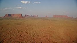 5.5K aerial stock footage of a wide view of Eagle Mesa, Sentinel Mesa in Monument Valley, Utah, Arizona, sunset Aerial Stock Footage | AX133_001