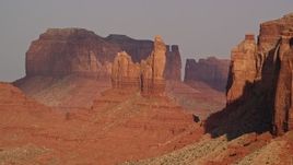 5.5K aerial stock footage of passing by Setting Hen Butte, Monument Valley, Utah, Arizona, sunset Aerial Stock Footage | AX133_006E
