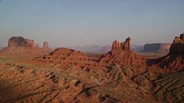 5.5K aerial stock footage of Setting Hen Butte in Monument Valley, Utah, Arizona, sunset Aerial Stock Footage | AX133_008