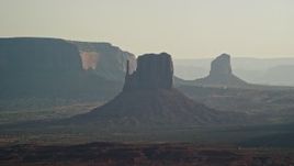 5.5K aerial stock footage of flying by West Mitten Butte, Mitchell Butte in Monument Valley, Utah, Arizona, twilight Aerial Stock Footage | AX133_021