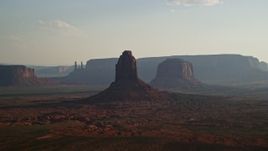 5.5K aerial stock footage flyby buttes, mesas, desert valley, Monument Valley, Utah, Arizona, twilight Aerial Stock Footage | AX133_024E