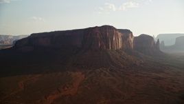 5.5K aerial stock footage of a view of Spearhead Mesa in desert valley, Monument Valley, Utah, Arizona, twilight Aerial Stock Footage | AX133_033