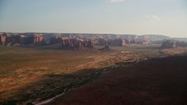 5.5K aerial stock footage of approaching buttes, mesas across desert, Monument Valley, Utah, Arizona, twilight Aerial Stock Footage | AX133_034E