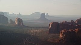 5.5K aerial stock footage of flying past mesas and buttes in Monument Valley, Utah, Arizona, twilight Aerial Stock Footage | AX133_049E