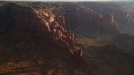 5.5K aerial stock footage of passing Hunt's Mesa and rock formations, Monument Valley, Utah, Arizona, sunset Aerial Stock Footage | AX133_055E
