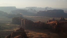 5.5K aerial stock footage of approaching mesas and buttes in Monument Valley, Utah, Arizona, sunset Aerial Stock Footage | AX133_057