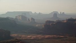 5.5K aerial stock footage of flying by buttes and mesas in Monument Valley, Utah, Arizona, sunset Aerial Stock Footage | AX133_058E