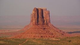 5.5K aerial stock footage of flying by East and West Mitten Buttes, Monument Valley, Utah, Arizona, twilight Aerial Stock Footage | AX133_084E