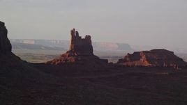 5.5K aerial stock footage of passing by Setting Hen Butte in Monument Valley, Utah, Arizona, twilight Aerial Stock Footage | AX133_089E