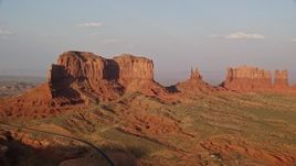 5.5K aerial stock footage of flying by buttes in Monument Valley, Utah, Arizona, twilight Aerial Stock Footage | AX133_091