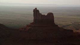 5.5K aerial stock footage of Setting Hen Butte in Monument Valley, Utah, Arizona, twilight Aerial Stock Footage | AX133_092