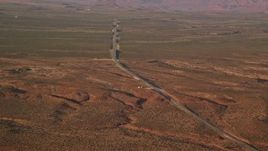 5.5K aerial stock footage of Highway 163 through desert valley, Monument Valley, Utah, Arizona, twilight Aerial Stock Footage | AX133_097E