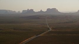 5.5K aerial stock footage flyby highway leading to buttes, Monument Valley, Utah, Arizona, twilight Aerial Stock Footage | AX133_103E