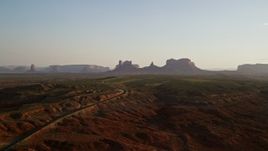 5.5K aerial stock footage of flying by buttes and mesas in Monument Valley, Utah, Arizona, twilight Aerial Stock Footage | AX133_114E